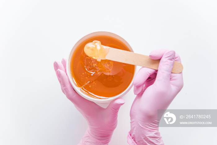 sugaring concept. flat lay. overhead view of bowl with cosmetology honey