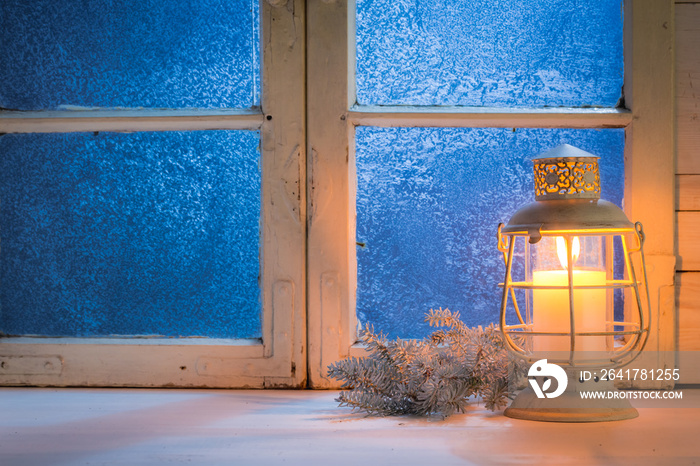 Frosted window with candle for Christmas