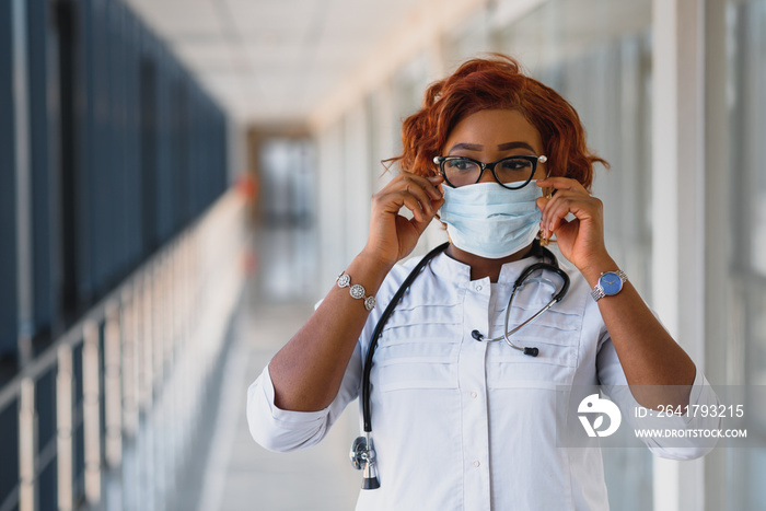 Young attractive african doctor with face mask