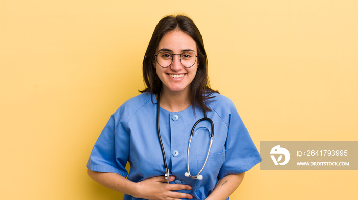 young hispanic woman laughing out loud at some hilarious joke. nurse concept