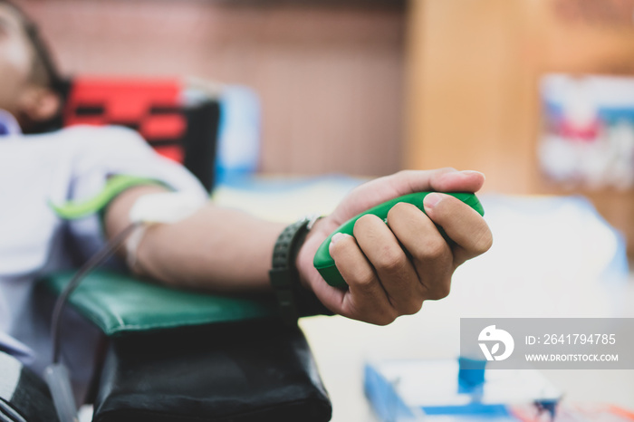 Blood transfusion donors donation with bouncy green ball holding in hand at hostpital to contribute 