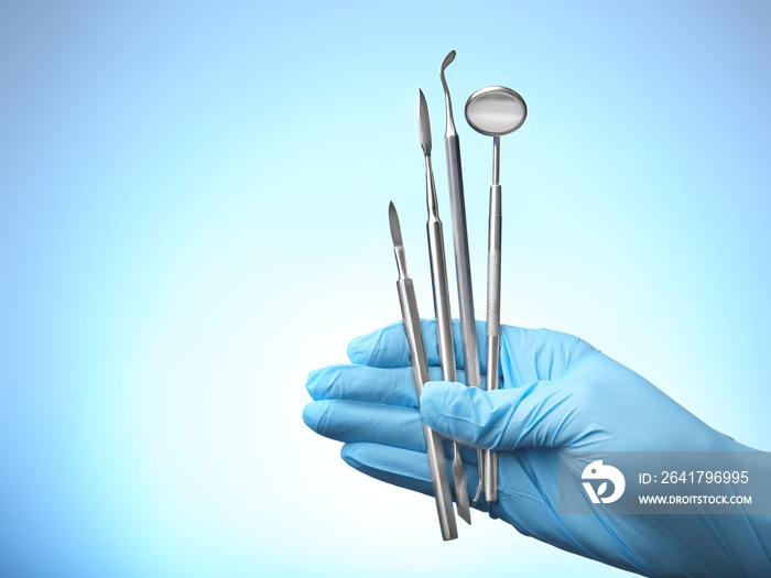 Hand holding dental equipment on white background