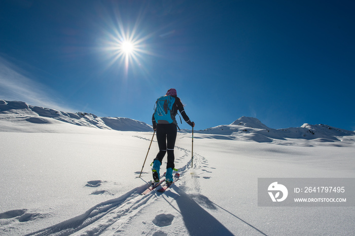 Uphill girl with seal skins and ski mountaineering