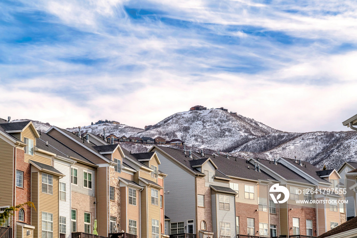 Snowy Wasatch Mountain viewed from a residential neighborhood with townhouses