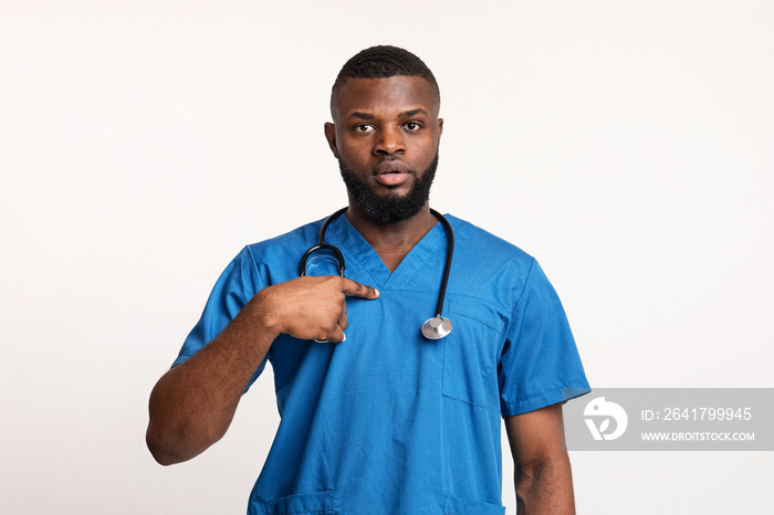 Surprised african male doctor pointing at himself