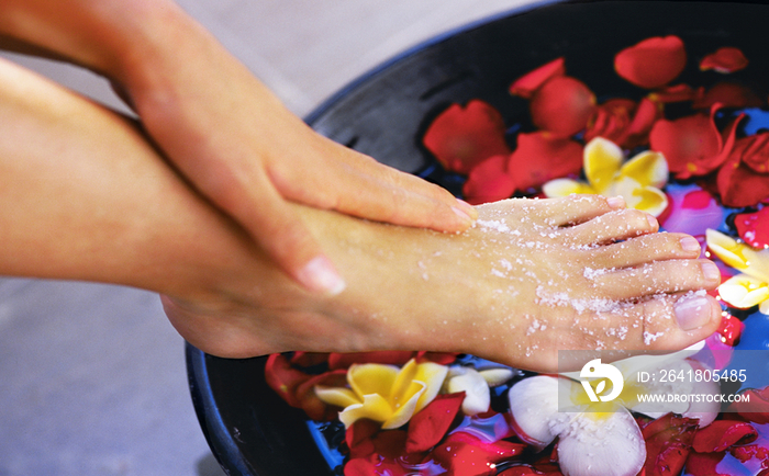 Woman having floral foot bath