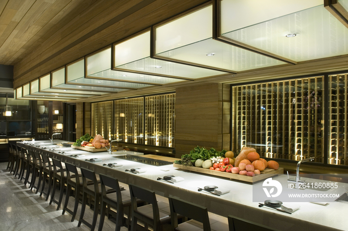 Long dining table and chairs in restaurant