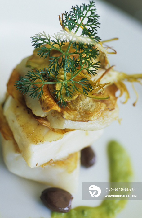 Stacked pieces of turbot with bicoloured sauce