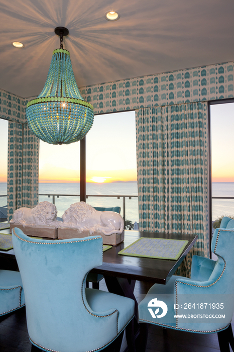 Lit beaded chandelier above dining table; California; United States of America