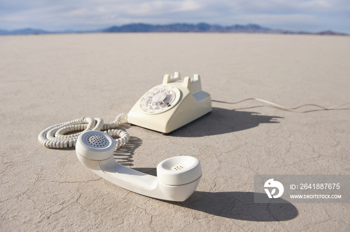 White Telephone on Dried Mud