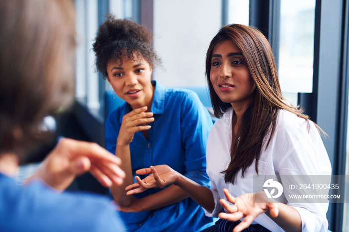 Woman explaining business strategy to coworkers