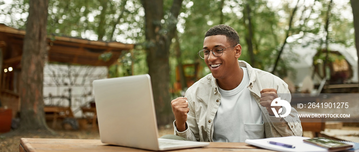 Smiling young african american man holding fists