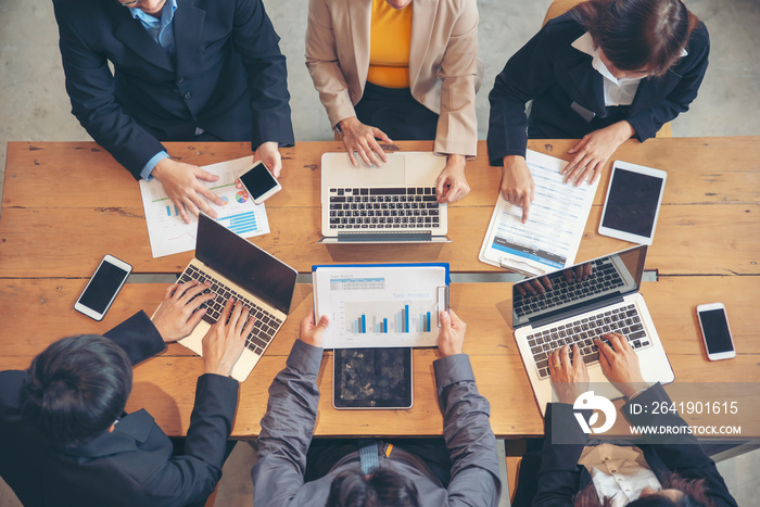 Group of People working together with laptop on wooden office desk. Professional business team meeti