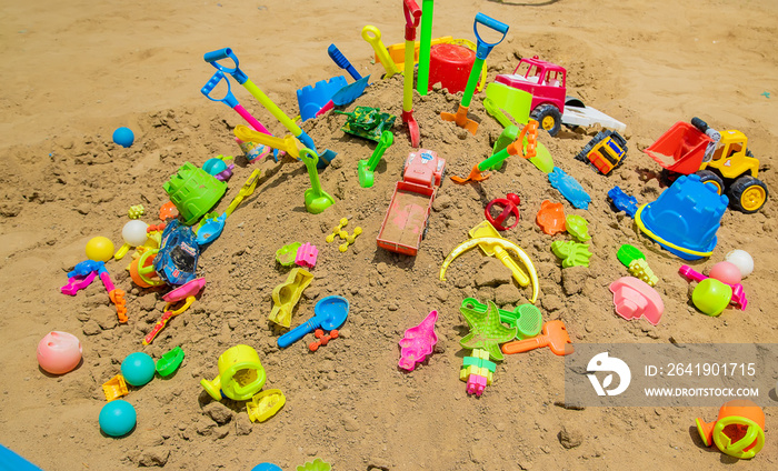 lot of childrens toys in the sandbox. Selective focus.