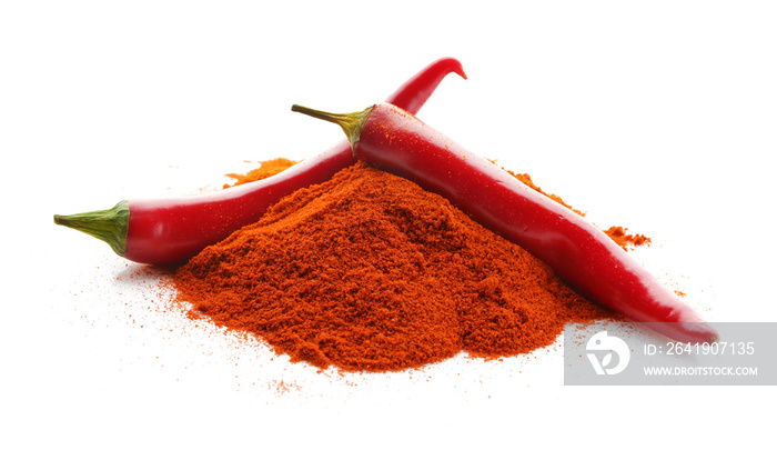 Pile of red chili powder with whole pepper pods isolated on white