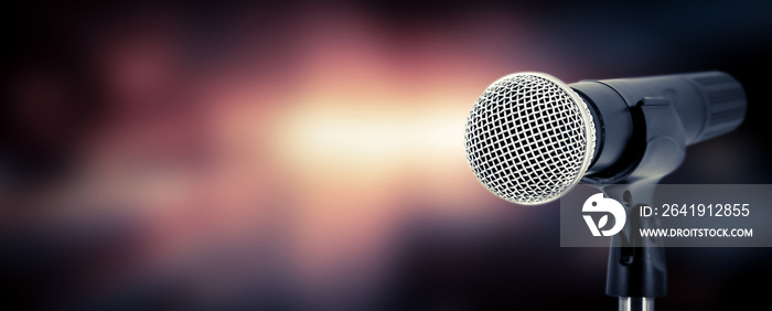 Microphone with stage light background for performance concept of speech comment and public speaking