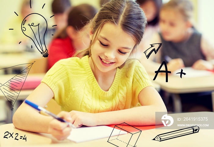 group of school kids writing test in classroom