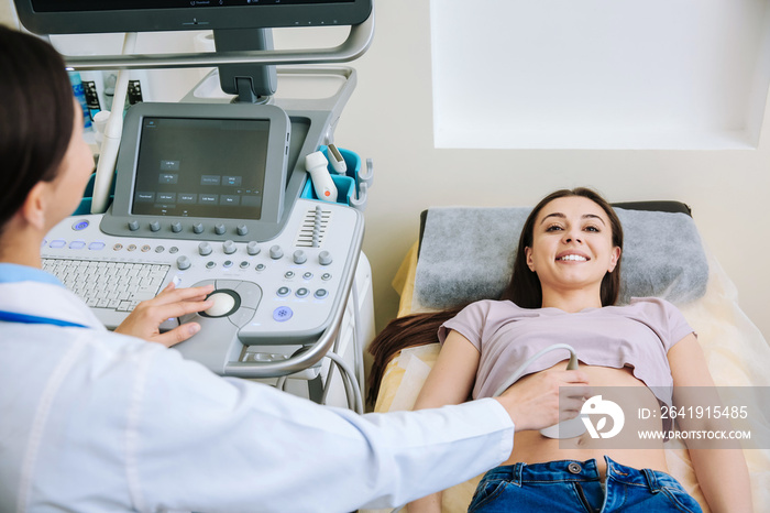 Woman undergoing ultrasound scan in clinic