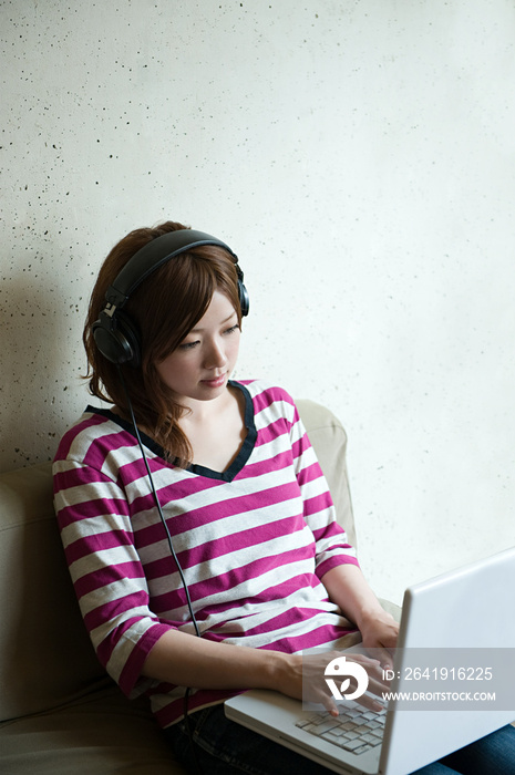 Young woman with headphones and laptop