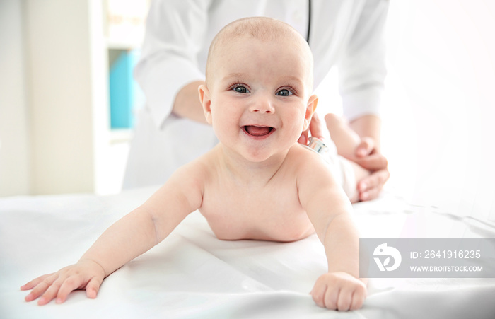 Professional pediatrician examining infant