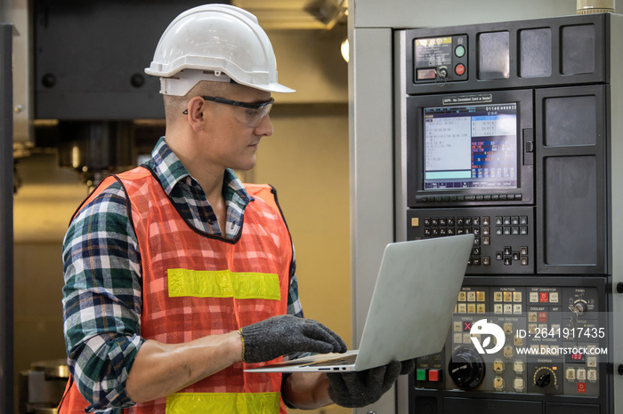 Engineer control and check robot working in factory. The worker is controlling the robot to work in 