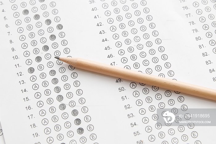 Standardized test form with answers bubbled in and a pencil, foc