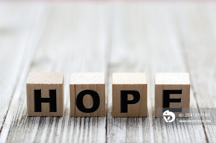 Hope word on square wooden blocks on a wooden background