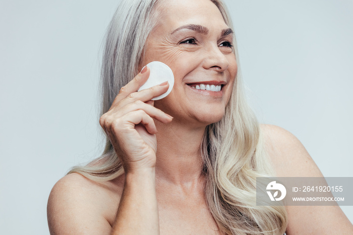 Woman cleansing her face