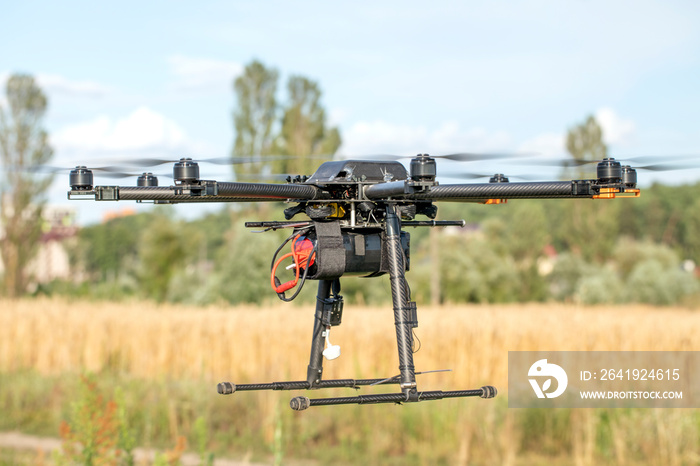 Big black homemade eight motor hexacopter on sky background.