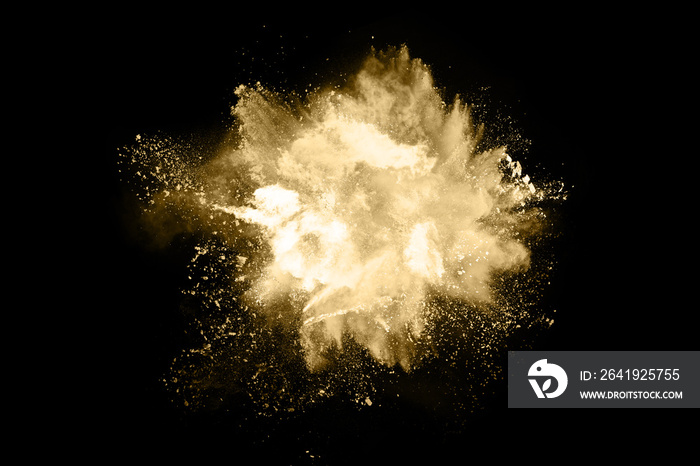 Golden powder explosion on black background. Freeze motion.