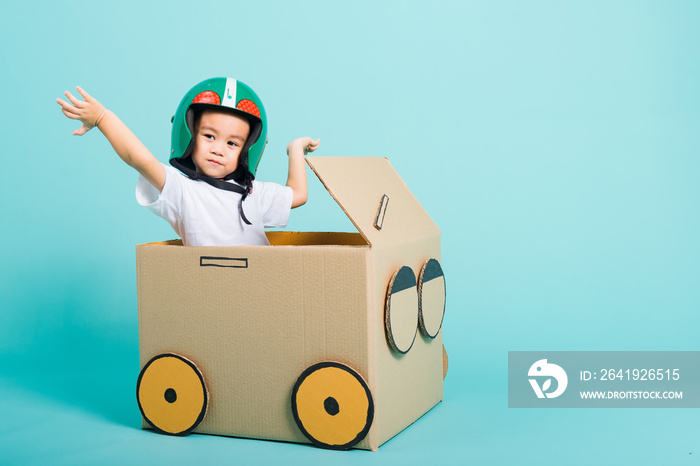 Baby children boy smile in driving play car creative by a cardboard box