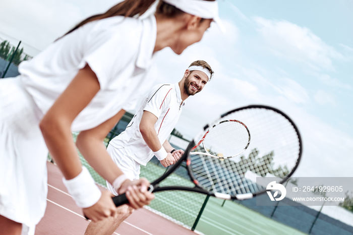 Active weekend together. Couple plays tennis