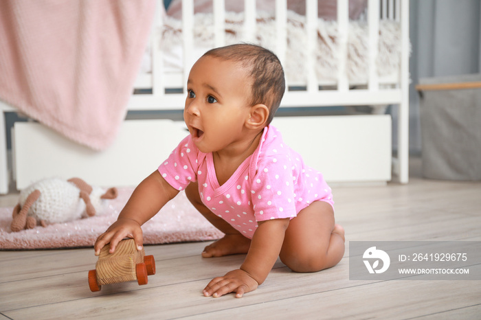 Cute African-American baby playing at home