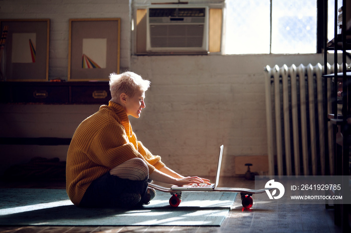 Young man using laptop in living room