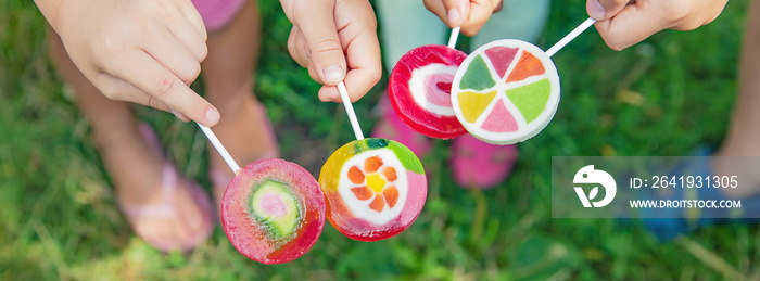 Lollipops in the hands of children. Selective focus.