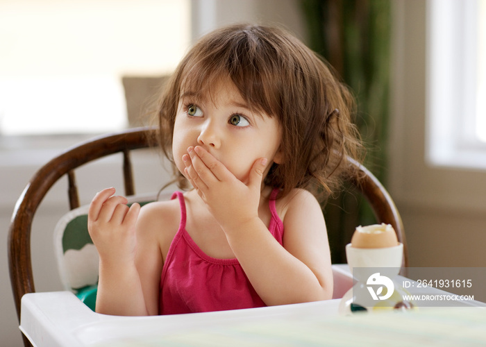 Girl eating egg