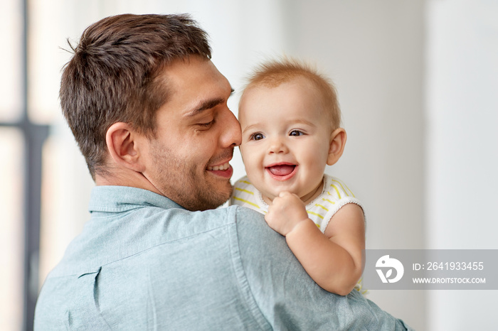 family, fatherhood and people concept - happy father holding little baby daughter at home