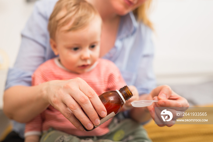 little boy taking cough medicine