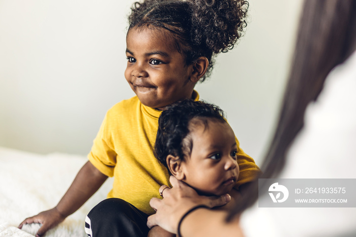 Portrait of enjoy happy love family african american mother playing with adorable little african ame