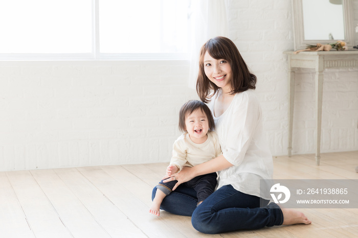 asian mother and child relaxing in living room