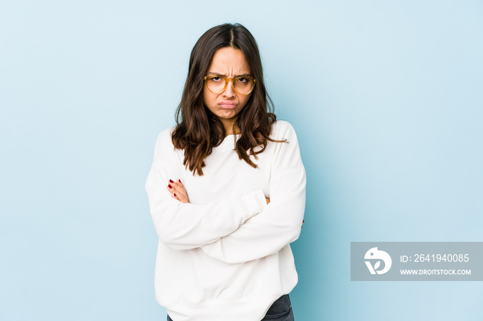 Young mixed race hispanic woman isolated frowning face in displeasure, keeps arms folded.