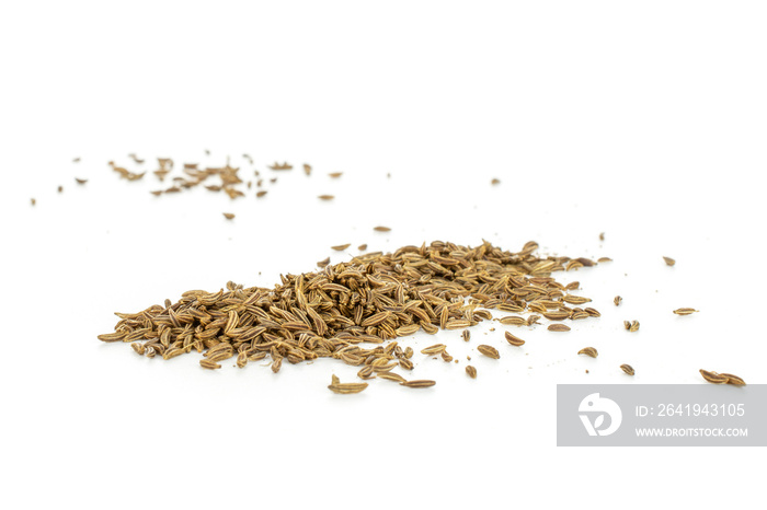 Lot of whole dry caraway fruits closeup isolated on white background