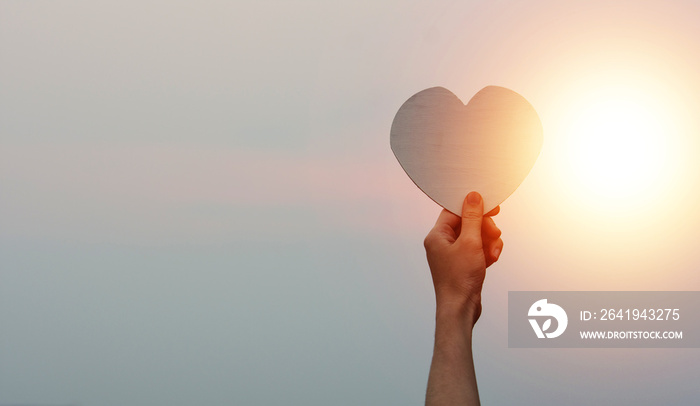 Hand holding heart on sky sunset , Love in Valentines day, Happy Valentine, World heart day