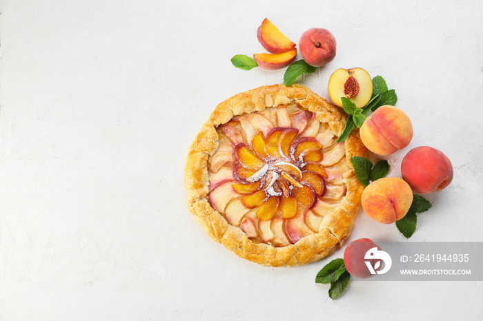 Tasty peach galette on light background