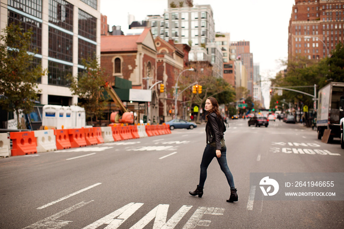 Young woman crossing street