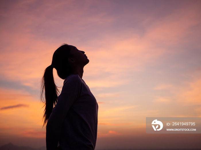 silhouette of young woman freedom feeling at sunset,thinking