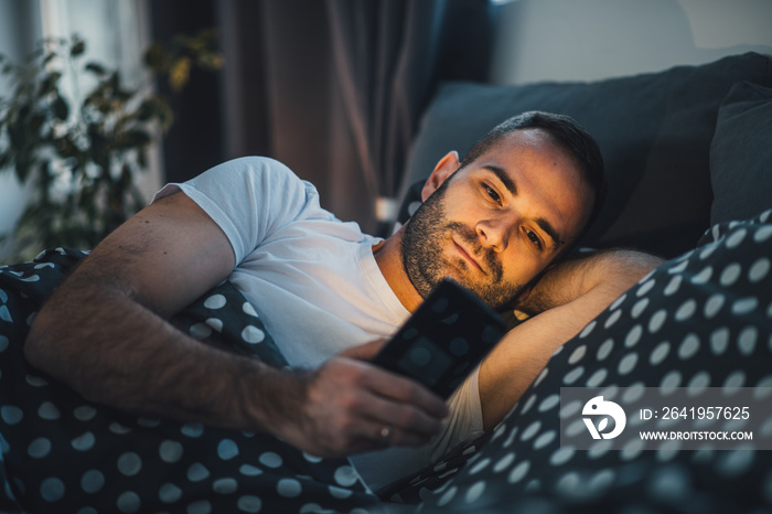 young cell phone addict man using smartphone for chatting, sending text messages