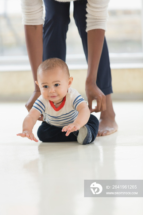 Cute baby boy crawling on floor