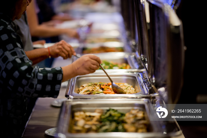 scooping the food, buffet food at restaurant, catering