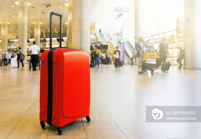 Suitcase in airport airport terminal waiting area with lounge zone as a background. Traveling luggag